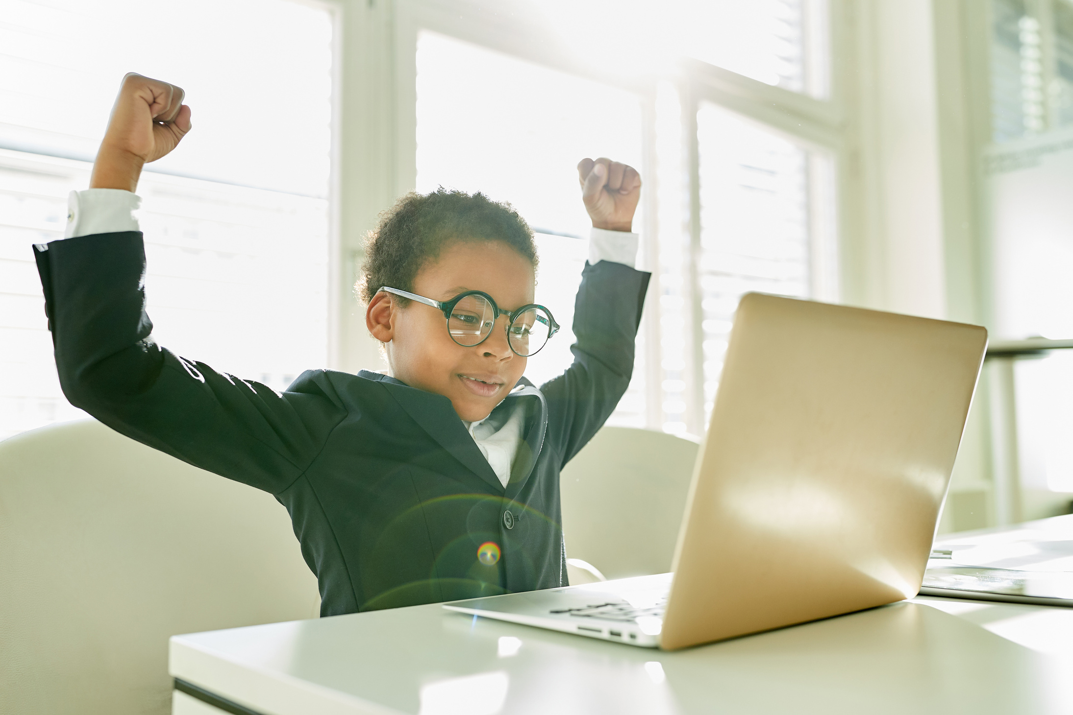 Cheering Kid as Manager at Laptop Computer